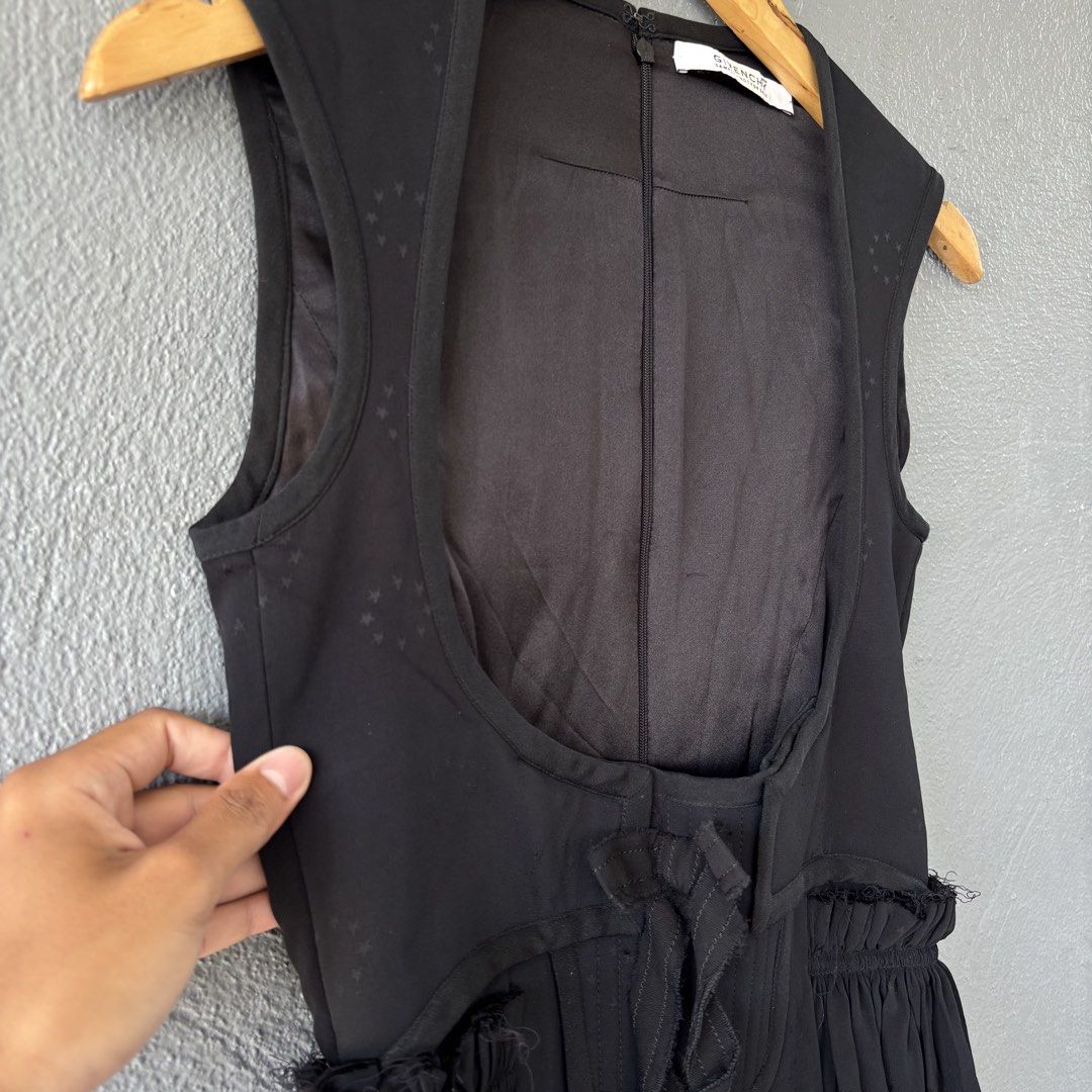Givenchy Sample Black Sleeveless Dress with Star Pattern (Category: Dresses) located in San Fernando. Submitted by diff.thr1ft (Listing ID 1466169916, Image 3). Description: - Brand: Givenchy - Condition: Sample piece with original tag attached - Color: Black with subtle tonal woven star pattern - Style: Sleeveless dress with open-front vest-like overlay and waist tie - Silhouette: Gathered flared skirt - Closure: Back zipper with hook and eye at