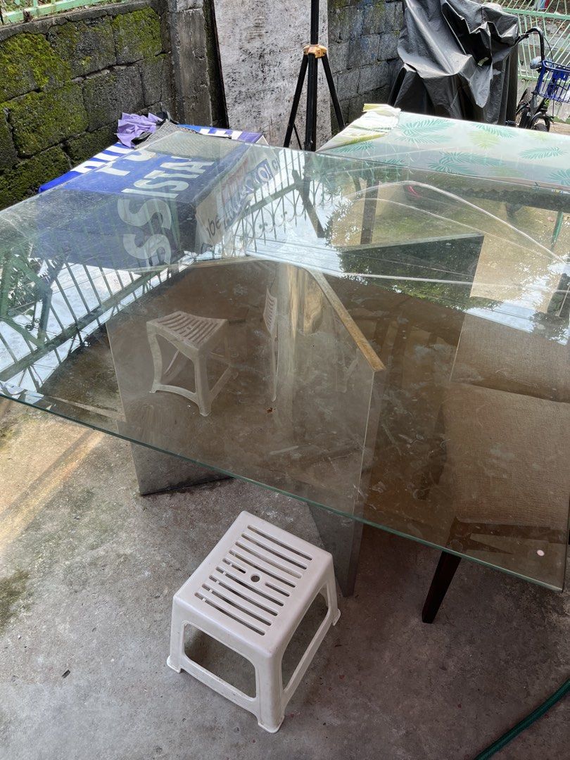 Glass top dining table with chrome base (Category: Tables & Sets) located in Manila. Submitted by sabrinaa20 (Listing ID 1466254679, Image 1). Description: - Modern square dining table - Thick glass top with normal surface wear (no cracks) - Shiny chrome metal pedestal base - Seats 8 comfortably - Sturdy, heavy build for maximum stability - Pick up only (due to size and weight).