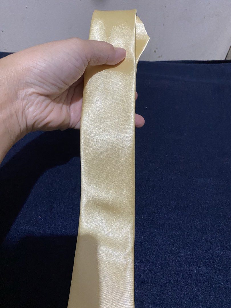 Gold satin necktie (Category: Ties) located in Manila. Submitted by resi.diaz (Listing ID 1466244587, Image 2). Description: - Color: Smooth gold with a subtle sheen - Material: 100% durable and easy-to-care-for polyester - Width: Standard blade - Style: Solid, classic design - Occasion: Ideal for formal wear, weddings, or office attire - Condition: Brand new with clean tag attached.