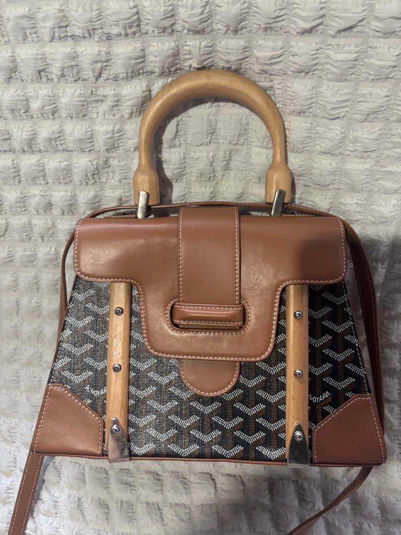 Goyard Saigon Structured Top Handle Bag (Category: Luxury Bags & Wallets) located in Rizal. Submitted by riri.rarapreloved (Listing ID 1466241064, Image 1). Description: - Goyard Saigonsignature chevron canvas with tan leather trim - Features a luxury wooden top handle and secure flip-lock front closure with leather flap detail - Vibrant yellow fabric interior with a convenient slip pocket - Includes a detachable shoulder strap for versatile styl