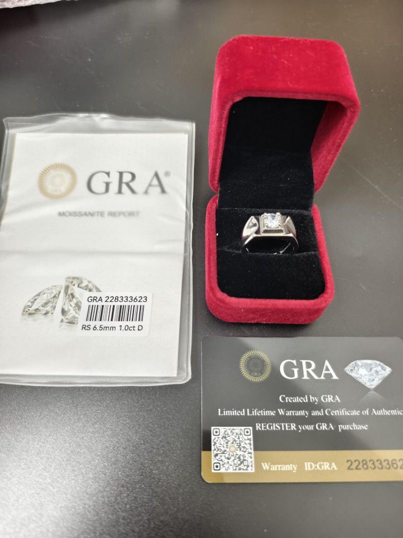 GRA Moissanite Ring 1.0ct D 6.5mm (Category: Rings) located in Angeles City. Submitted by measaliman02351 (Listing ID 1466225888, Image 3). Description: - Center Stone: 1.0ct D color moissanite (6.5mm) - Setting: Secure silver-tone band - Inclusions: Original red velvet ring box, GRA moissanite report, and authenticity warranty card (ID: 228333623) - Condition: Brand new, ready for gifting or personal wear.