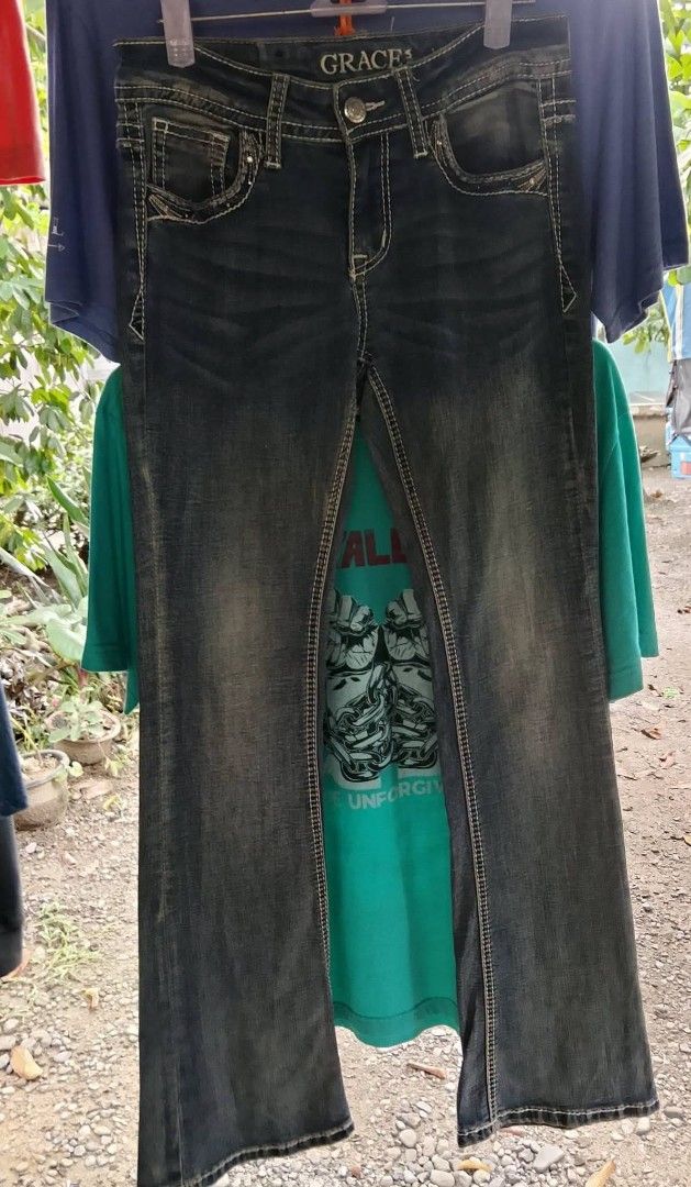 Grace in LA Jeans Size 14 (Category: Jeans) located in Manila. Submitted by keencrystal.595c28 (Listing ID 1466310100, Image 3). Description: - Brand: Grace in LA - Size: 14 - Wash: Medium dark with front whiskering - Details: Embellished back pockets with winged embroidery and rhinestone studs, white contrast stitching - Material: 72% cotton, 26% polyester, 2% elastane - Features: Button closure, belt loops, standard 5-pocket design.