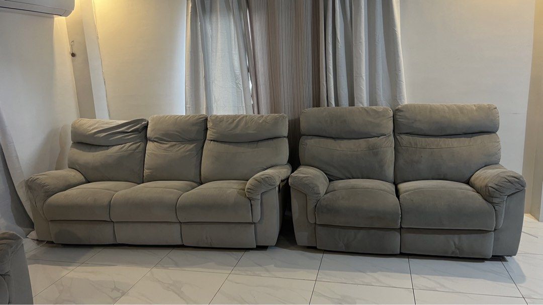 Gray reclining sofa set with multiple seats (Category: Sofas) located in Santa Rosa. Submitted by chachi10201 (Listing ID 1466193788, Image 1). Description: - Gray fabric reclining sofa set (3-seater and 2-seater configuration) - Smooth manual pull recline mechanism on all seats - Foam padding remains very plush and supportive - Condition: Shows light staining and minor fraying along one cushion seam - Perfect, budget-friendly upgrade for any fam