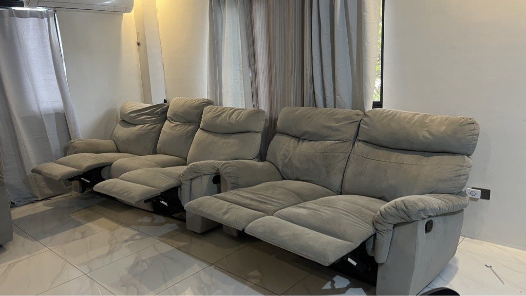 Gray reclining sofa set with multiple seats (Category: Sofas) located in Santa Rosa. Submitted by chachi10201 (Listing ID 1466193788, Image 2). Description: - Gray fabric reclining sofa set (3-seater and 2-seater configuration) - Smooth manual pull recline mechanism on all seats - Foam padding remains very plush and supportive - Condition: Shows light staining and minor fraying along one cushion seam - Perfect, budget-friendly upgrade for any fam