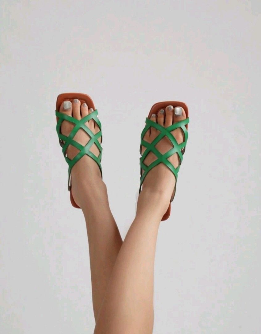 Green Strappy Flat Sandals Square Toe (Category: Flats & Sandals) located in Mandaluyong City. Submitted by zheida1068 (Listing ID 1466297565, Image 1). Description: Comfortable green slip-on sandals with brown flat soles and a chic square toe. Features a stylish criss-cross strap design and a low heel, perfect for everyday walking..