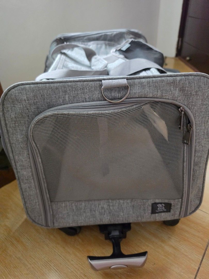 Grey rolling pet carrier trolley with mesh window (Category: Homes & Other Pet Accessories) located in Marikina City. Submitted by joerispe (Listing ID 1466158759, Image 1). Description: - Color: Sleek grey - Material: Durable, high-quality fabric - Ventilation: Built-in front mesh window for excellent airflow - Mobility: Sturdy side extendable handle and smooth bottom wheels - Carrying Options: Dual top carry handles or pull trolley style - Clos