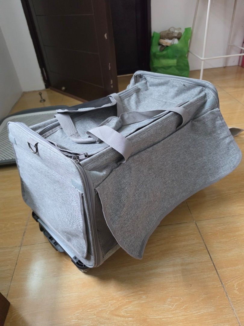 Grey rolling pet carrier trolley with mesh window (Category: Homes & Other Pet Accessories) located in Marikina City. Submitted by joerispe (Listing ID 1466158759, Image 2). Description: - Color: Sleek grey - Material: Durable, high-quality fabric - Ventilation: Built-in front mesh window for excellent airflow - Mobility: Sturdy side extendable handle and smooth bottom wheels - Carrying Options: Dual top carry handles or pull trolley style - Clos