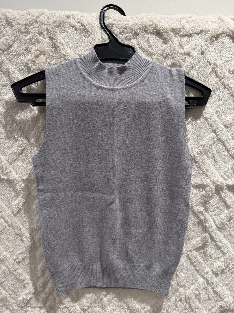 Grey sleeveless mock neck knit top (Category: Sleeveless) located in San Juan City. Submitted by ich711 (Listing ID 1466268635, Image 1). Description: - Color: Grey - Style: Sleeveless knit top with mock neckline - Details: Ribbed collar and hem, stylish center front seam - Material: Soft, comfortable knit - Fit: Regular, great for layering or wearing on its own - Condition: Used once - Mode of Payment: GCash .