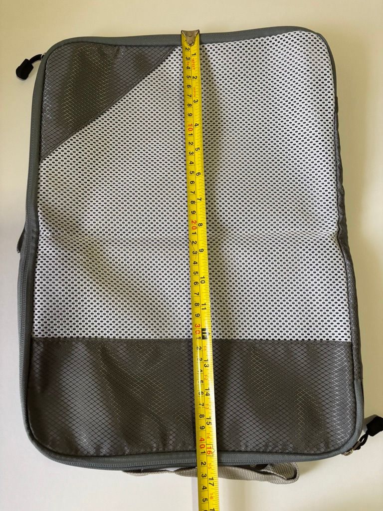 Grey Travel Compression Packing Cube Mesh Organizer (Category: Travel Essentials & Accessories) located in Quezon City. Submitted by leahs.stuff (Listing ID 1466216896, Image 3). Description: - Color: Grey - Size: Approximately 20 cm wide - Mesh top panel for easy visibility of contents - Durable ripstop fabric on bottom and corners - Secure zipper closure with pull tab - Handy loop handle at the bottom for easy grabbing - Ideal for luggage organ