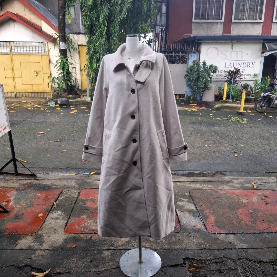 GU Melton Balmacaan Coat (Category: Coats, Jackets and Outerwear) located in Manila. Submitted by arzhelfromsjs (Listing ID 1466231335, Image 1). Description: - Color: Classic beige - Style: Long trench coat with front buttons and lapel collar - Features: Functional pockets and buttoned strap details on sleeves - Interior: Fully lined with a smooth fabric finish - Best for: Great layering piece for cooler weather.