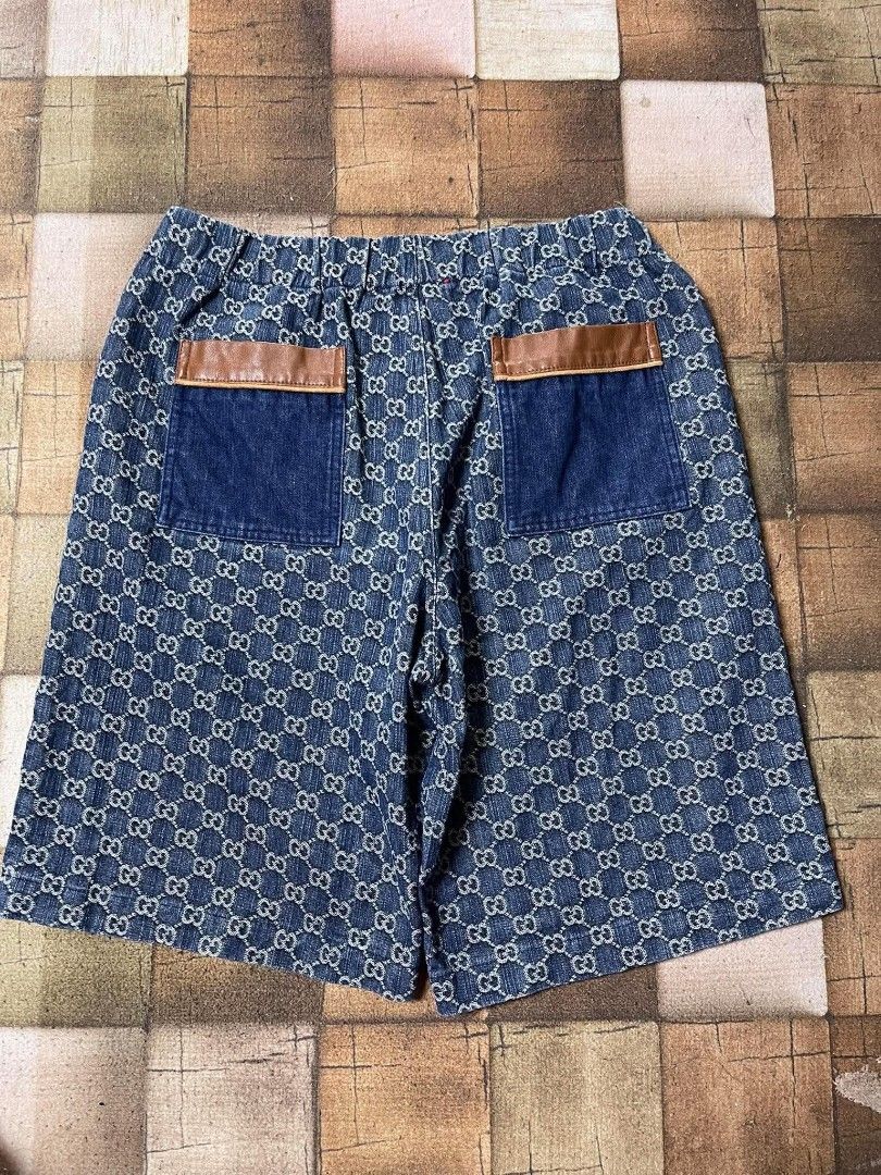 Gucci GG Denim Shorts Size 52 (Category: Shorts) located in Manila. Submitted by japee55 (Listing ID 1466266242, Image 2). Description: - Brand: Gucci - Style: Denim shorts with classic GG monogram pattern - Size: 52 (Made in Italy) - Waistband: Elastic for a comfortable fit - Pockets: Two front and two back pockets with brown leather accents - Condition: Great piece for warm weather styling.