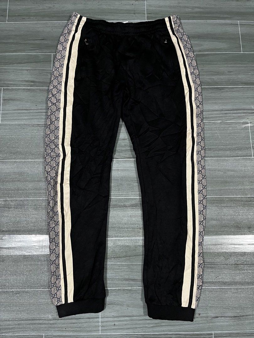 Gucci GG Monogram Track Pants Black Size S (Category: Joggers) located in Cabuyao City. Submitted by undergroundthrift03 (Listing ID 1466319419, Image 1). Description: - Brand: Gucci - Color: Black with white and black side stripes - Details: Signature GG monogram pattern on outer side panels, drawstring waist, and front zipper pockets - Fit/Size: Size S (175/78A) with ribbed ankle cuffs - Material & Origin: Soft fabric, Made in Italy - Style: Cl