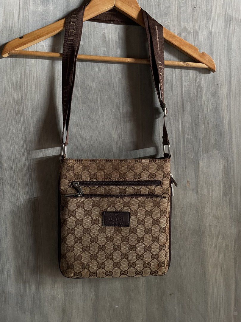 Gucci Monogram Crossbody Bag Brown (Category: Luxury Bags & Wallets) located in M'Lang. Submitted by thrift_finds2 (Listing ID 1466177288, Image 2). Description: - Authentic Gucci monogram crossbody bag in brown canvas and leather - Features iconic repeating GG pattern and branded brown fabric strap - Secure main top zipper closure with convenient front zippered pocket - Interior lined in black with official Gucci leather stamp patch - Perfect ha