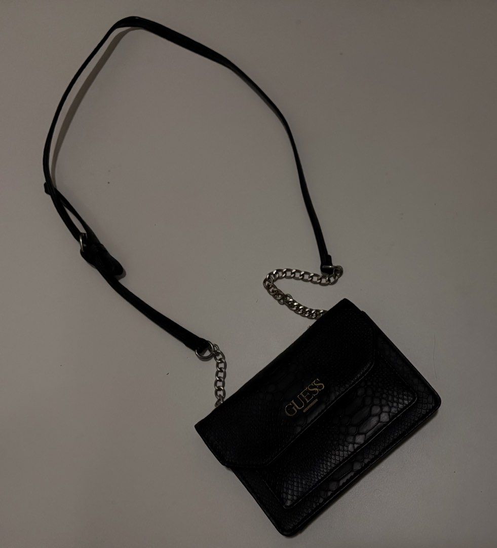 GUESS Black Snake Embossed Shoulder Bag (Category: Cross-body Bags) located in Mandaluyong City. Submitted by alexadkdy (Listing ID 1466319170, Image 1). Description: - Authentic GUESS shoulder bag - Color: Black - Material: Snake-embossed faux leather - Silver-tone chain detail - Magnetic flap closure - Adjustable shoulder strap - Good preloved condition - Minimal signs of use - No major flaws, tears, or hardware issues - Please check all photos