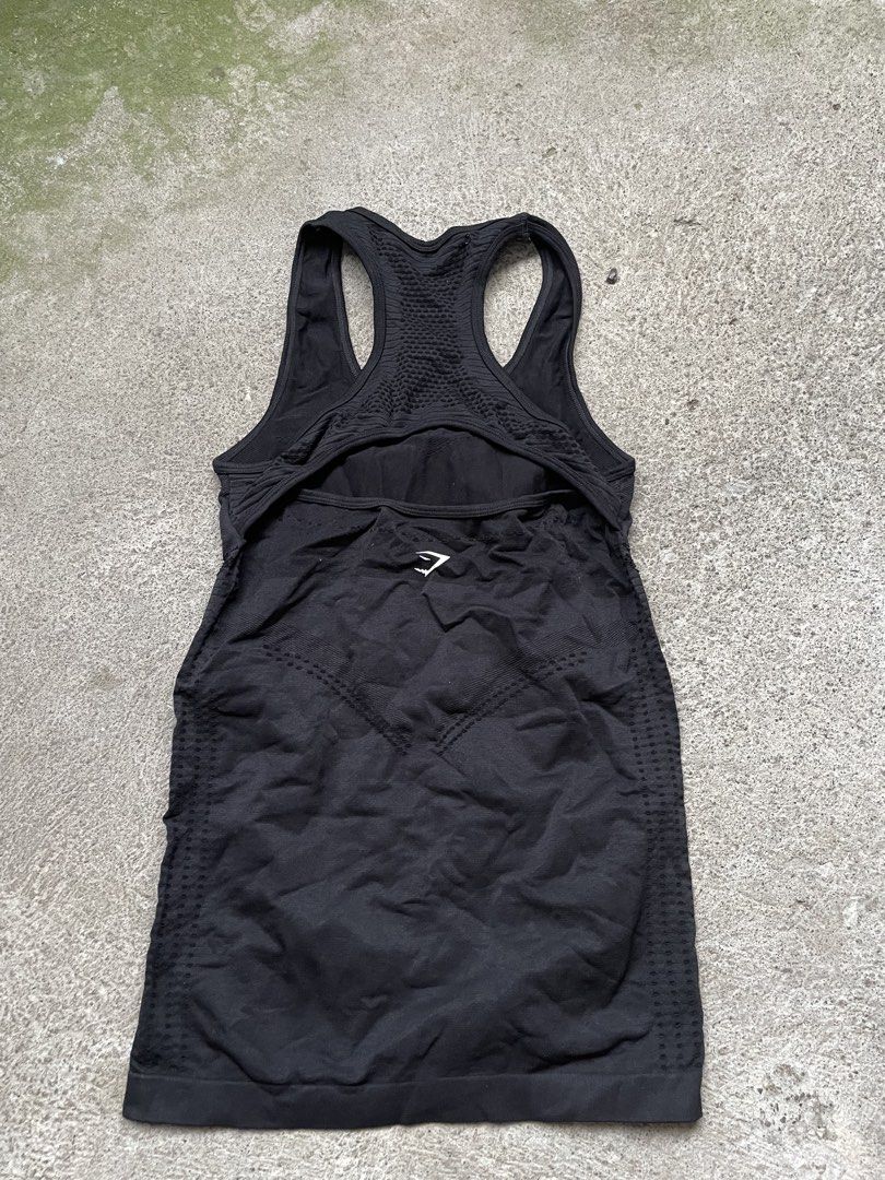 Gymshark Black Seamless Tank Top (Category: Activewear) located in Siniloan. Submitted by rethr1ft (Listing ID 1466245170, Image 2). Description: - 24 length | 14 width - Authentic Gymshark activewear tank top in classic black - Racerback design with white logo lettering on the shoulder strap - Built-in inner lining provides extra coverage and support during workouts - Stretchy, breathable seamless fabric featuring stylish contour knit patterns -