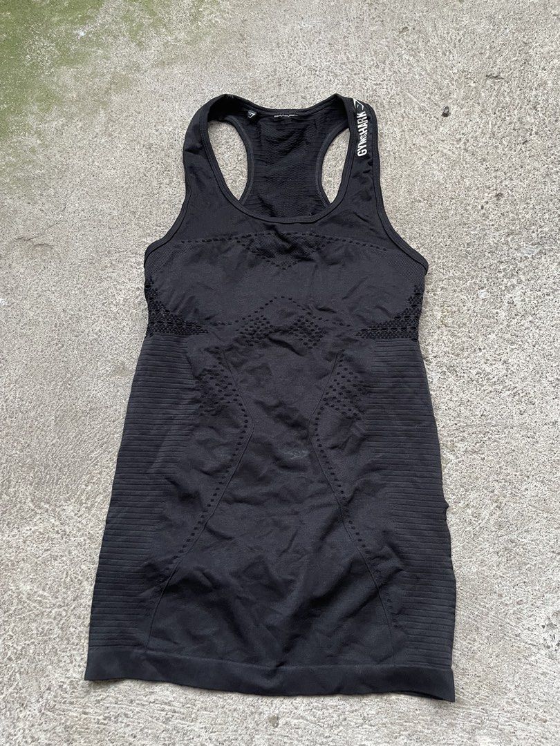 Gymshark Black Seamless Tank Top (Category: Activewear) located in Siniloan. Submitted by rethr1ft (Listing ID 1466245170, Image 1). Description: - 24 length | 14 width - Authentic Gymshark activewear tank top in classic black - Racerback design with white logo lettering on the shoulder strap - Built-in inner lining provides extra coverage and support during workouts - Stretchy, breathable seamless fabric featuring stylish contour knit patterns -