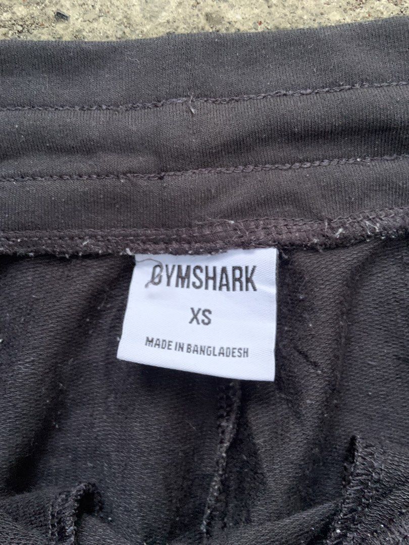 Gymshark Black Sweatpants with White Logo (Category: Joggers) located in Tabaco. Submitted by bayhust (Listing ID 1466267129, Image 3). Description: - Authentic Gymshark black sweatpants - Classic white sharkhead logo printed on the left thigh 28-34 waist 38 length 4 leg opening - Features a comfortable elastic waistband and side pockets - Made from ultra-soft cotton material - Standard fit, ideal for workouts or everyday lounging.