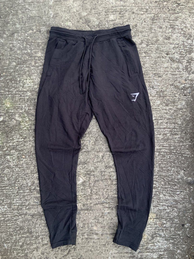 Gymshark Black Sweatpants with White Logo (Category: Joggers) located in Tabaco. Submitted by bayhust (Listing ID 1466267129, Image 1). Description: - Authentic Gymshark black sweatpants - Classic white sharkhead logo printed on the left thigh 28-34 waist 38 length 4 leg opening - Features a comfortable elastic waistband and side pockets - Made from ultra-soft cotton material - Standard fit, ideal for workouts or everyday lounging.