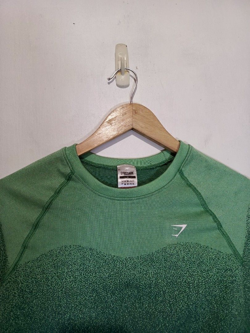 GYMSHARK CROP TOP (Category: Longsleeves) located in Baguio. Submitted by 074thriftmania (Listing ID 1466254846, Image 2). Description: - Brand: Gymshark - Style: Seamless long sleeve crop top with crew neck - Design: Green ombre dot fade down the body and arms with white chest logo - Size: Medium - Material: 54% polyester, 36% nylon, 10% elastane - Origin: Made in Turkey - Condition: Excellent length 13" width 14".