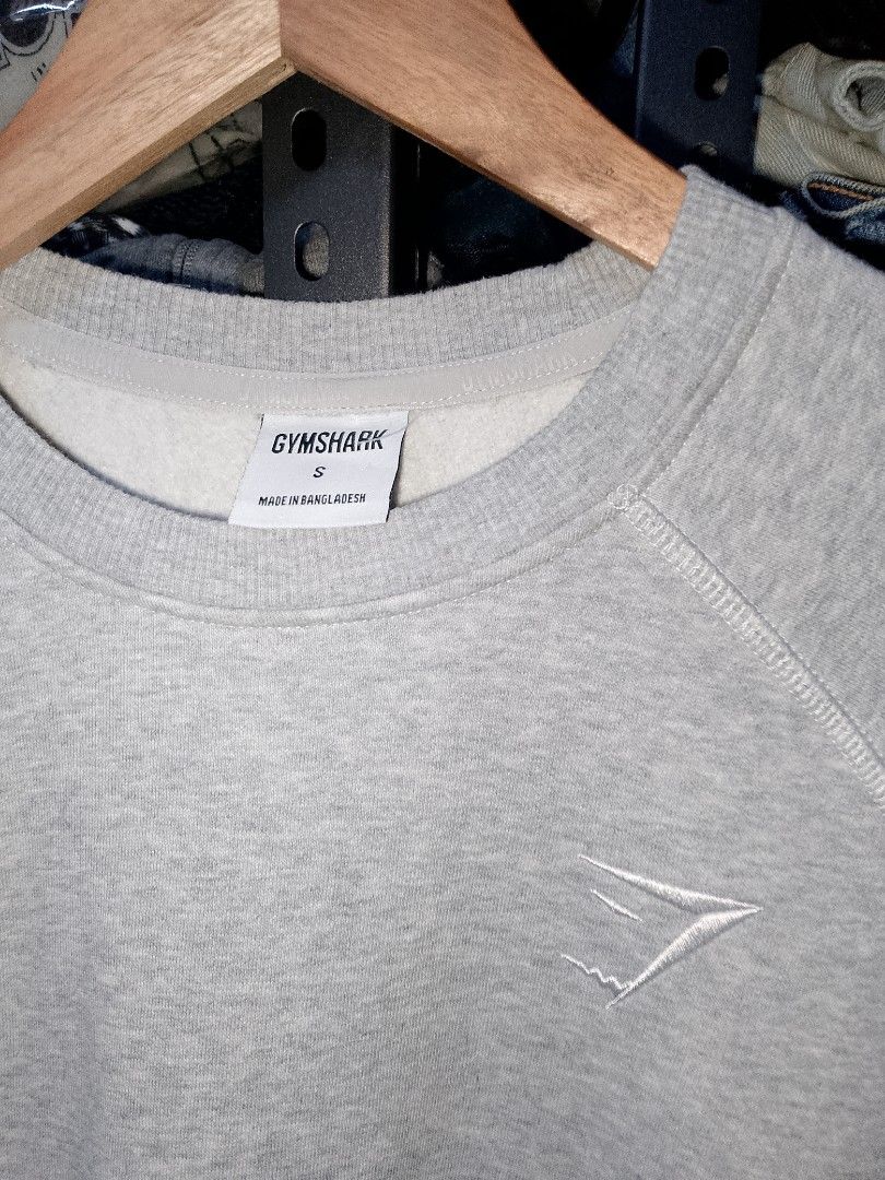 Gymshark Grey Sweatshirt Size S (Category: Coats, Jackets and Outerwear) located in Manila. Submitted by mjthrifted_second (Listing ID 1466207570, Image 3). Description: - Brand: Gymshark - Style: Classic crewneck pullover sweatshirt - Size: Small -Dimes: 21/27.5 - Color: Grey with small embroidered white chest logo - Material: Comfortable cotton and polyester blend - Details: Long sleeves with ribbed cuffs and hem - Condition: Pre-loved, well-ma