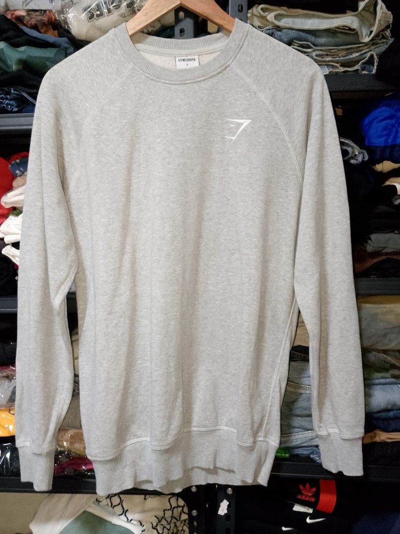 Gymshark Grey Sweatshirt Size S (Category: Coats, Jackets and Outerwear) located in Manila. Submitted by mjthrifted_second (Listing ID 1466207570, Image 1). Description: - Brand: Gymshark - Style: Classic crewneck pullover sweatshirt - Size: Small -Dimes: 21/27.5 - Color: Grey with small embroidered white chest logo - Material: Comfortable cotton and polyester blend - Details: Long sleeves with ribbed cuffs and hem - Condition: Pre-loved, well-ma