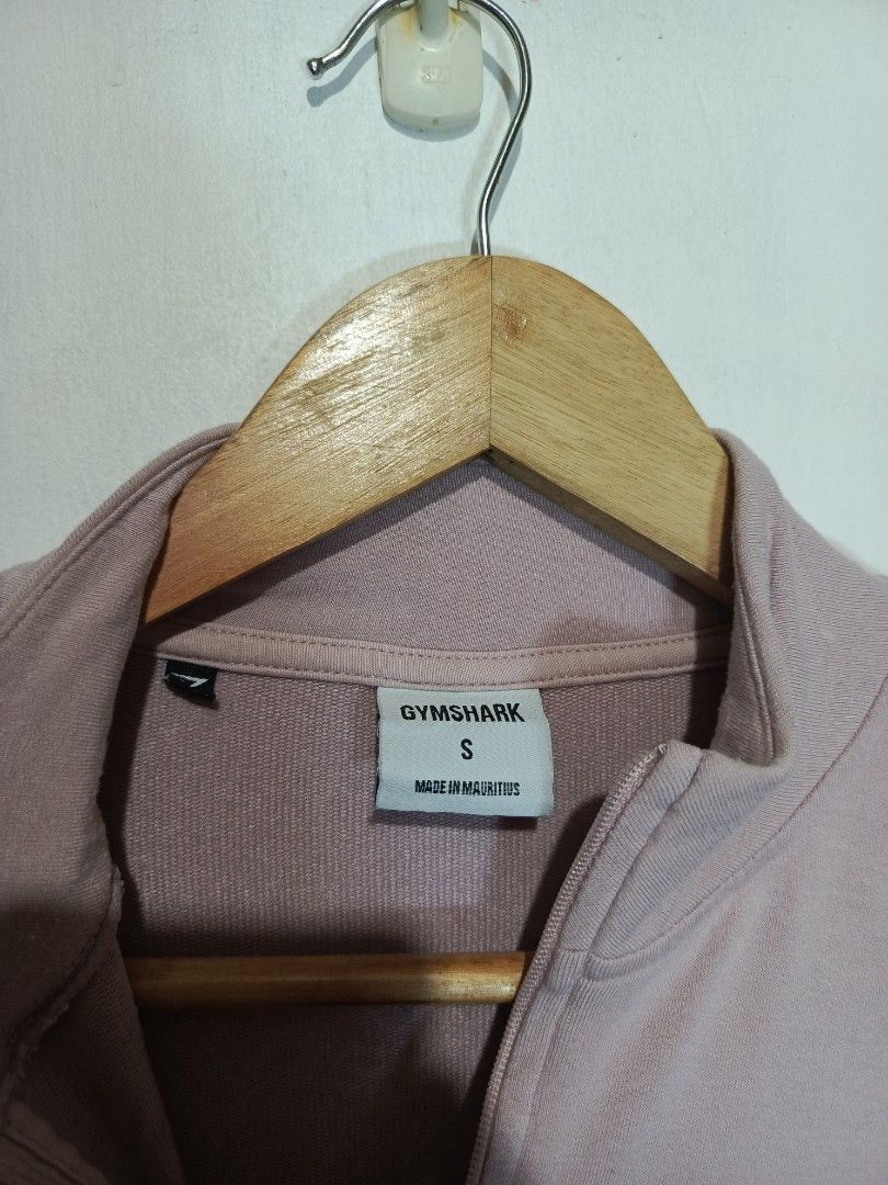 GYMSHARK QUARTER ZIP CROP JACKET (Category: Activewear) located in Baguio. Submitted by 074thriftmania (Listing ID 1466254582, Image 3). Description: - Brand: Gymshark - Color: Pink with white shoulder branding - Size: Small (S) - Style: Quarter-zip, high neck, front pouch pocket, cropped length - Material: Viscose, polyester, and elastane blend - Origin: Made in Mauritius - Condition: Great for workouts or casual wear length 18" width 19".