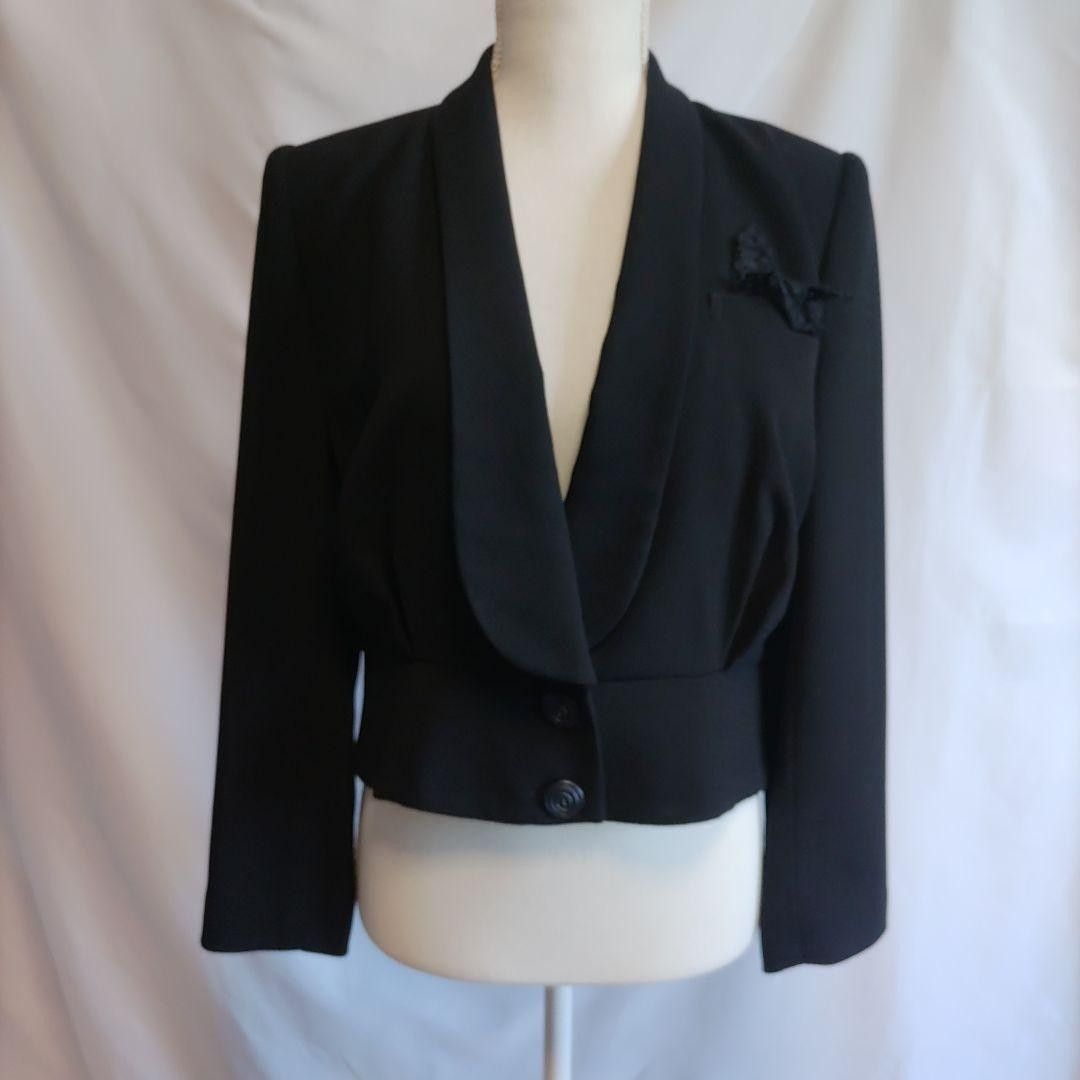 Hardy Amies London black coat MEDIUM (Category: Coats, Jackets and Outerwear) located in Valenzuela. Submitted by anna.banana10 (Listing ID 1466165918, Image 1). Description: - Brand: Hardy Amies London - Size: 11 - Color: Solid black with a textured feel - Style: Cropped blazer with a chic shawl collar and wide two-button hem - Details: Structured shoulders with slight gathering, fully lined interior, and a removable lace accent pin on the chest