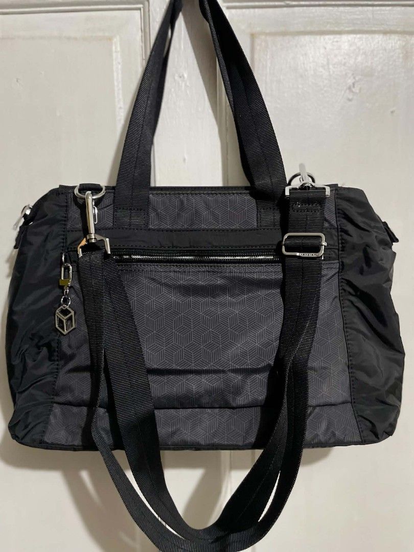 Hedgren Eva-M shoulder bag (Category: Tote Bags) located in Manila. Submitted by xtinamendo00659 (Listing ID 1466286877, Image 1). Description: - Brand: Hedgren - Color: Classic Black - Design: Stylish geometric cube pattern on front and back with a matching cube keychain - Material: Durable, high-quality nylon - Compartments: Multiple zippered pockets inside and outside for easy organization - Carry Options: Dual carry handles and an adjustable,