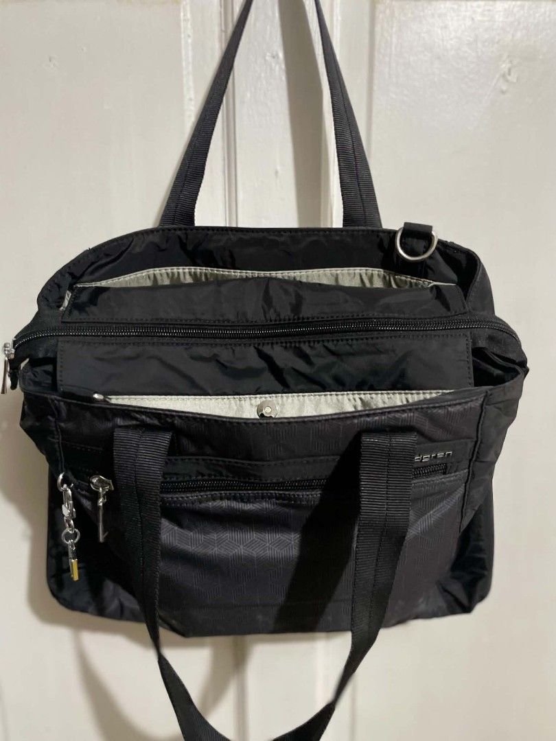 Hedgren Eva-M shoulder bag (Category: Tote Bags) located in Manila. Submitted by xtinamendo00659 (Listing ID 1466286877, Image 2). Description: - Brand: Hedgren - Color: Classic Black - Design: Stylish geometric cube pattern on front and back with a matching cube keychain - Material: Durable, high-quality nylon - Compartments: Multiple zippered pockets inside and outside for easy organization - Carry Options: Dual carry handles and an adjustable,