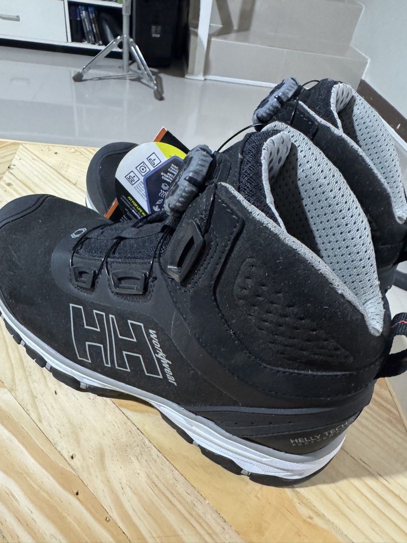 Helly Hansen Workwear BOA Safety Boots (Category: Boots) located in Cavite. Submitted by marcuz1316 (Listing ID 1466252027, Image 1). Description: Helly Hansen workwear boots in black. Helly Tech performance waterproofing. BOA dial lace system instead of standard laces. ESD protection tag attached. White and grey midsole with heavy-duty rubber grip on the bottom. Original tags still hanging off the side. High-top ankle support with breathable gre