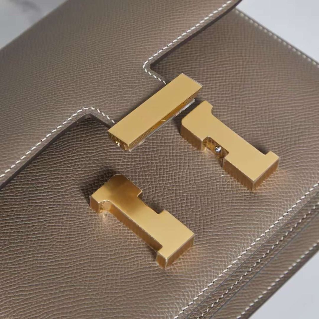 Hermes Constance Etoupe Epsom Gold Hardware Bag (Category: Luxury Bags & Wallets) located in Pasay City. Submitted by manoethoub52982 (Listing ID 1466204005, Image 3). Description: - Brand: Hermes Constance - Color: Etoupe with contrast white stitching - Material: Durable Epsom leather - Hardware: Iconic gold-tone H clasp lock - Interior: Double gusset layout with divided compartments and slip pockets - Design: Structured rectangular shape with t