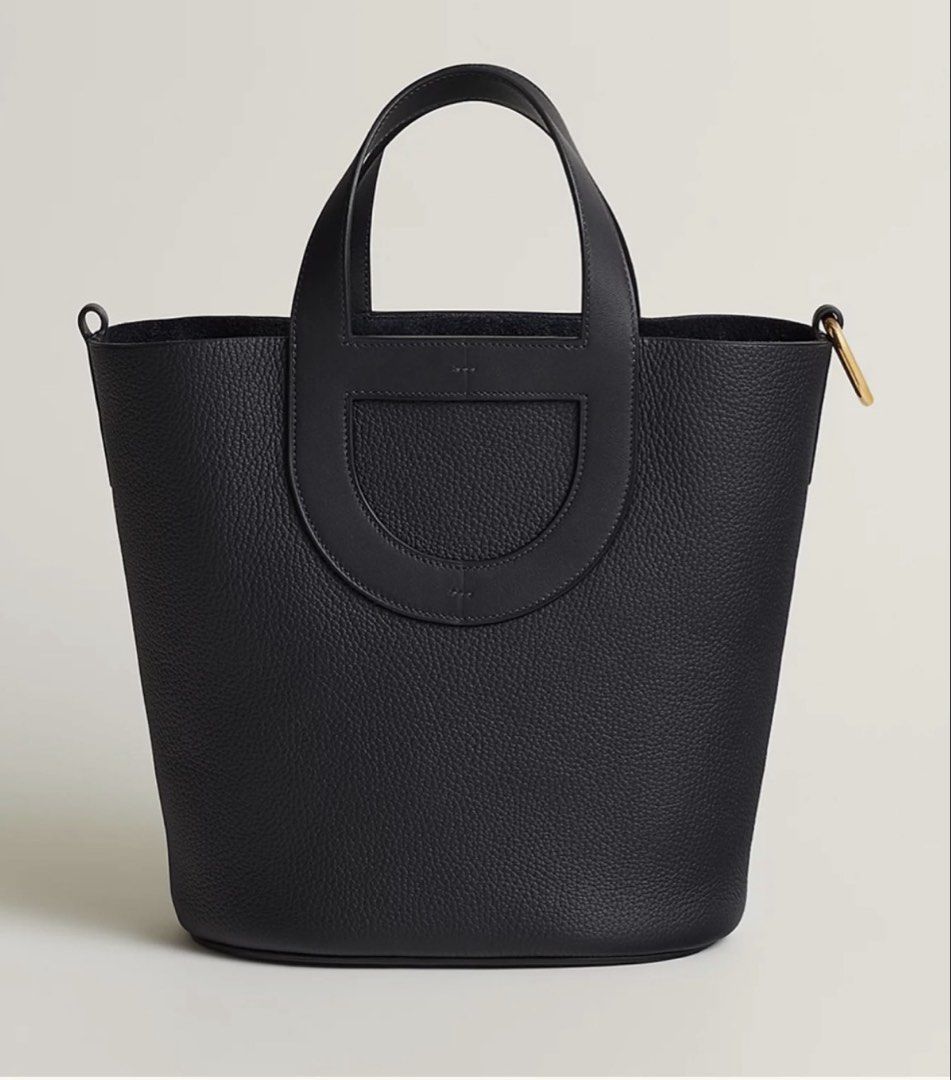 Hermes In-The-Loop Black Leather Bucket Bag (Category: Shoulder Bags) located in Quezon City. Submitted by eight.eight (Listing ID 1466308440, Image 1). Description: - Brand: Hermès - Model: In-The-Loop Bucket Bag - Material: Premium grained black leather - Hardware: Elegant gold-tone accents - Design: Iconic 'Chaîne d'Ancre' cutout leather motif on the front - Features: Dual top handles, side metal rings for strap attachment, structured oval bas