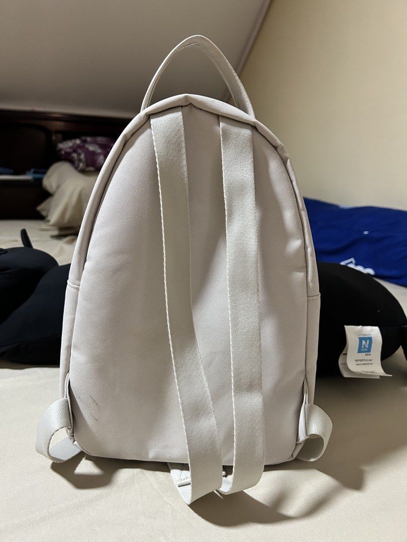 Herschel Nova Mini Backpack Moonbeam (Category: Backpacks) located in Agdangan. Submitted by keleusitel_ (Listing ID 1466191014, Image 3). Description: - Brand: Herschel Nova Mini Backpack - Color: Moonbeam (Versatile neutral off-white) - Condition: Good condition, seldom used. No major stains, tears, or damage. - Features: Twin top carry handles, adjustable shoulder straps, front zip pocket with exposed metal zipper, and classic logo patch - Rea