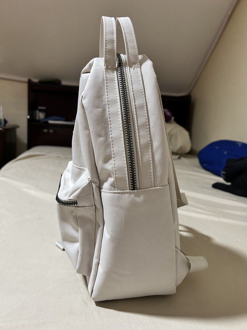 Herschel Nova Mini Backpack Moonbeam (Category: Backpacks) located in Agdangan. Submitted by keleusitel_ (Listing ID 1466191014, Image 2). Description: - Brand: Herschel Nova Mini Backpack - Color: Moonbeam (Versatile neutral off-white) - Condition: Good condition, seldom used. No major stains, tears, or damage. - Features: Twin top carry handles, adjustable shoulder straps, front zip pocket with exposed metal zipper, and classic logo patch - Rea