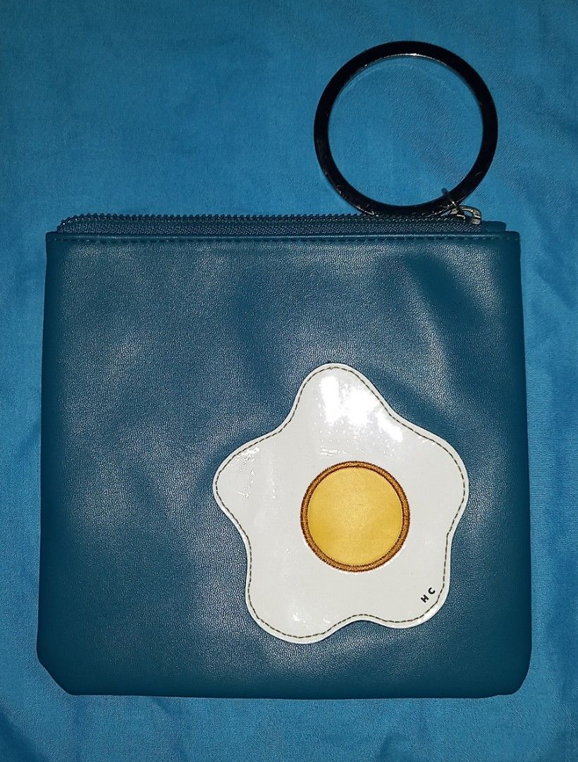 High Cheeks Pouch Fried Egg Gingham (Category: Purses & Pouches) located in Cagayan de Oro. Submitted by edwardryan01984 (Listing ID 1466167883, Image 1). Description: - Brand: High Cheeks - Design: Playful fried egg appliqué with deep teal faux leather front and green gingham check back - Hardware: Sturdy metal ring on the zipper corner for keys or wrist carrying - Closure: Smooth top zipper to keep your small essentials secure - Condition: Exce