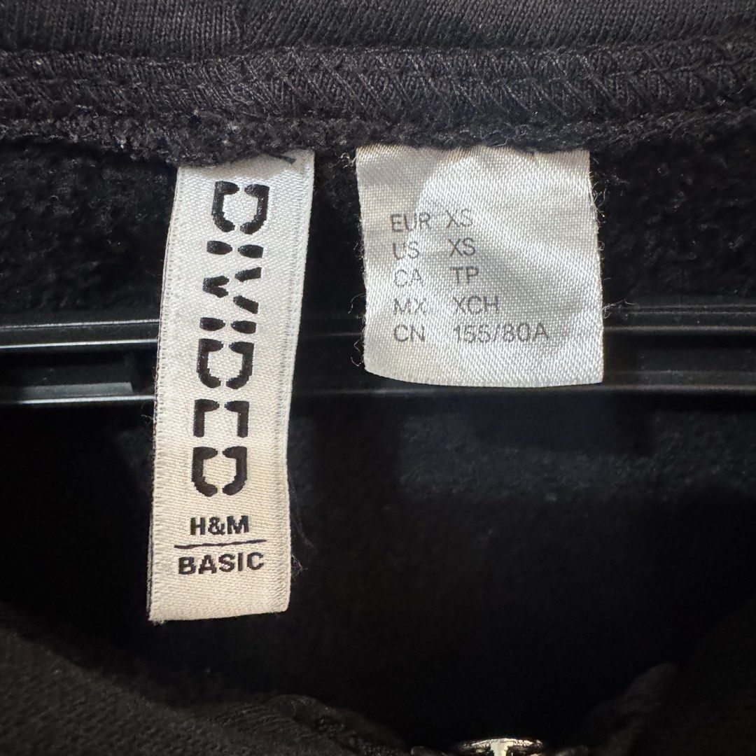 H&M Divided Basic Black Zip-up Hoodie (Category: Coats, Jackets and Outerwear) located in Marikina City. Submitted by preloved_n_reloved (Listing ID 1466240188, Image 2). Description: - Brand: H&M Divided Basic - Size: XS - Color: Solid Black - Features: Full front zipper, adjustable drawstrings at the hood, two front pouch pockets - Details: Ribbed cuffs and hem.
