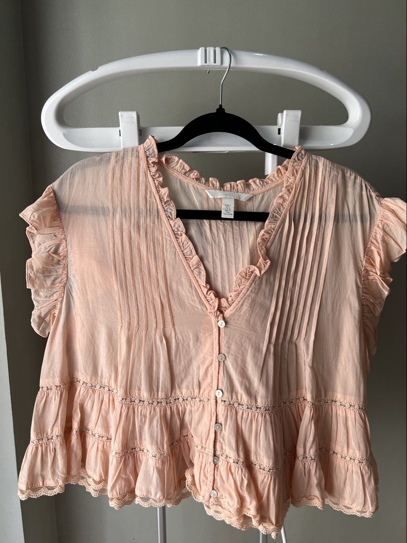 H&M Peach Ruffle Button-Down Blouse Size L (Category: Blouses) located in Davao. Submitted by bengscloset (Listing ID 1466202107, Image 1). Description: Brand: H&M Size: L Color: Peach Details: Ruffles, pintuck chest, layered tiered ruffles with lace trim & cropped style Condition: Clean and well-kept 📌 No rush shipping. 📦 Shipping fee c/o buyer. 📍Davao City 💌 Feel free to message me for additional photos/details. Thank you for checking out m