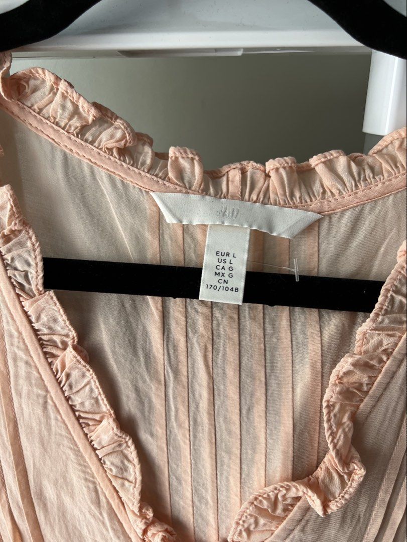H&M Peach Ruffle Button-Down Blouse Size L (Category: Blouses) located in Davao. Submitted by bengscloset (Listing ID 1466202107, Image 2). Description: Brand: H&M Size: L Color: Peach Details: Ruffles, pintuck chest, layered tiered ruffles with lace trim & cropped style Condition: Clean and well-kept 📌 No rush shipping. 📦 Shipping fee c/o buyer. 📍Davao City 💌 Feel free to message me for additional photos/details. Thank you for checking out m