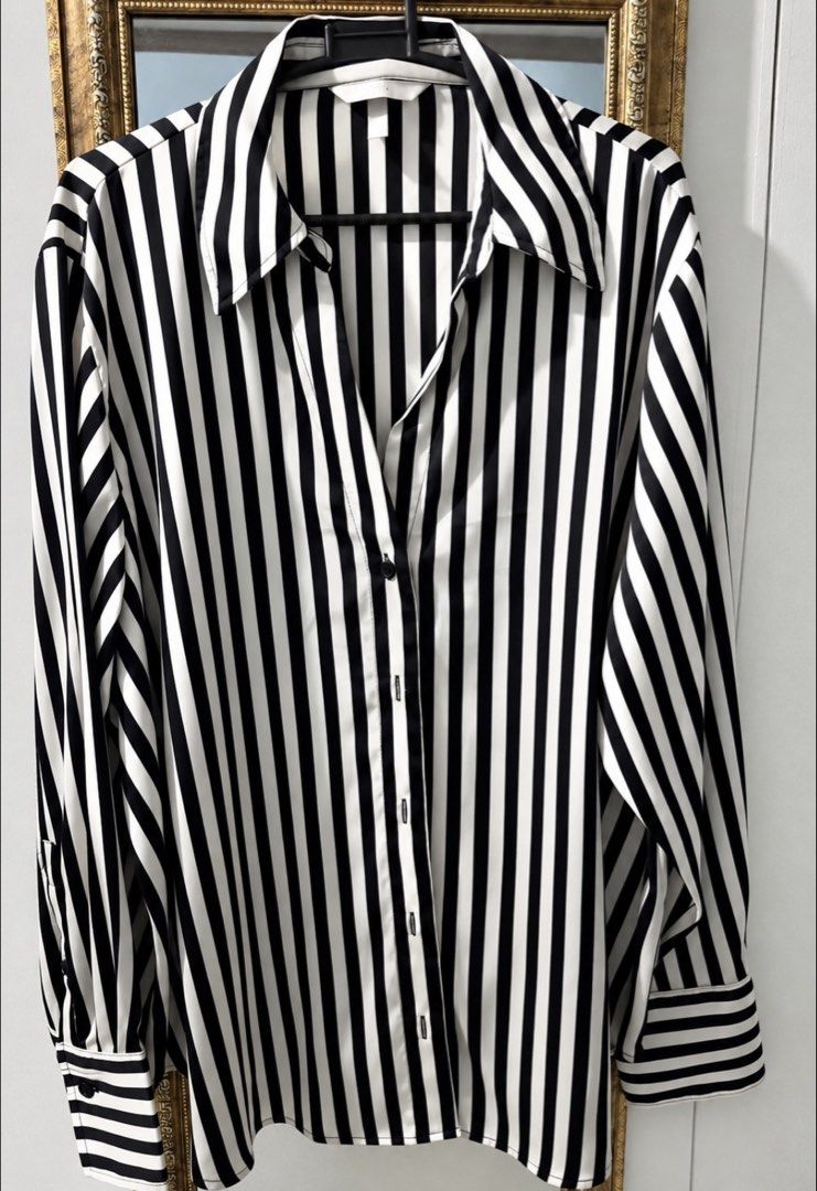 H&M White/Black striped Satin longsleeve (Category: Longsleeves) located in Cavite. Submitted by chicfinds.slay (Listing ID 1466314027, Image 1). Description: ✨ H&M Black and White Striped Button-Down Shirt. It is characterized by its bold vertical monochrome stripes, relaxed fit, classic pointed shirt collar, and long sleeves with vizcose satin texture ✨used once /no flaws ✨bought lastyr dec. ✨rfs: too long for me and purchased it for Christmas 