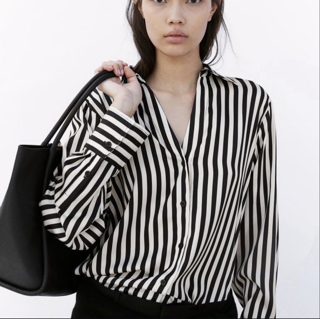 H&M White/Black striped Satin longsleeve (Category: Longsleeves) located in Cavite. Submitted by chicfinds.slay (Listing ID 1466314027, Image 3). Description: ✨ H&M Black and White Striped Button-Down Shirt. It is characterized by its bold vertical monochrome stripes, relaxed fit, classic pointed shirt collar, and long sleeves with vizcose satin texture ✨used once /no flaws ✨bought lastyr dec. ✨rfs: too long for me and purchased it for Christmas 