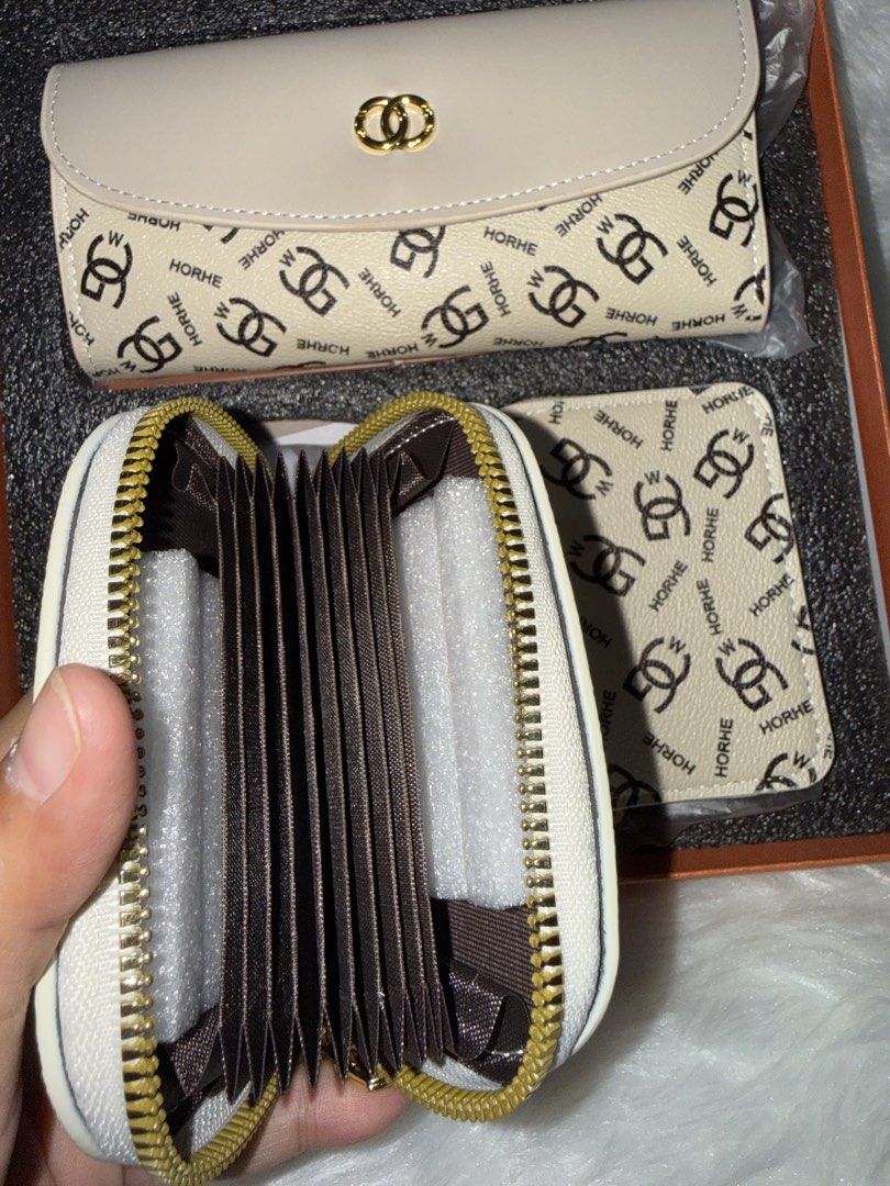 HORHE Monogram Print Wallet Set in Box (Category: Luxury Bags & Wallets) located in Taguig. Submitted by roseanneramirez (Listing ID 1466209382, Image 2). Description: Three-piece beige wallet set by HORHE featuring an all-over monogram logo print and black lettering. Includes a flap long wallet with a gold-tone clasp closure, a curved zip pouch, and an accordion card holder wallet with multiple interior card slots. All items come neatly packed i
