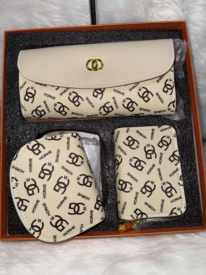 HORHE Monogram Print Wallet Set in Box (Category: Luxury Bags & Wallets) located in Taguig. Submitted by roseanneramirez (Listing ID 1466209382, Image 3). Description: Three-piece beige wallet set by HORHE featuring an all-over monogram logo print and black lettering. Includes a flap long wallet with a gold-tone clasp closure, a curved zip pouch, and an accordion card holder wallet with multiple interior card slots. All items come neatly packed i