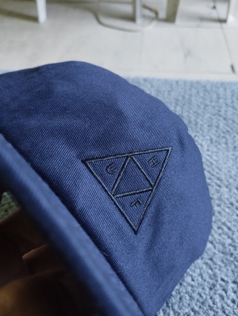 HUF Navy Blue Snapback Cap (Category: Caps & Hats) located in Manila. Submitted by happycaps (Listing ID 1466173299, Image 1). Description: - Brand: HUF - Style: 5-panel structured snapback cap - Color: Navy blue - Material: 100% cotton - Details: Embroidered HUF triangle logo on front - Closure: Adjustable matching plastic snapback with branded tag - Interior: Branded sweatband and intact care tags - Size: One size fits most - Origin: Made in Ch