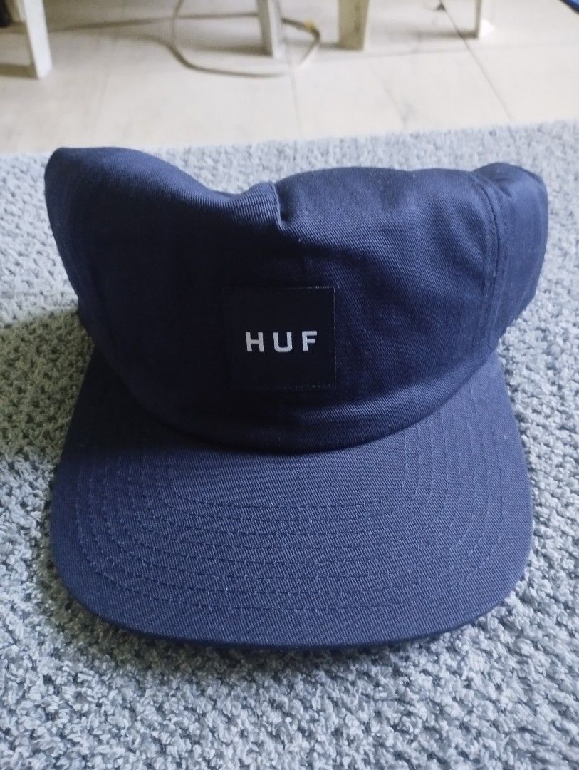 HUF Navy Blue Snapback Hat Cap (Category: Caps & Hats) located in Manila. Submitted by happycaps (Listing ID 1466172758, Image 1). Description: - Brand: HUF - Color: Navy Blue - Material: 100% Cotton twill - Design: Square woven patch logo on front - Fit: Adjustable plastic snap closure (One Size Fits All) - Condition: Clean fabric, great streetwear accessory.