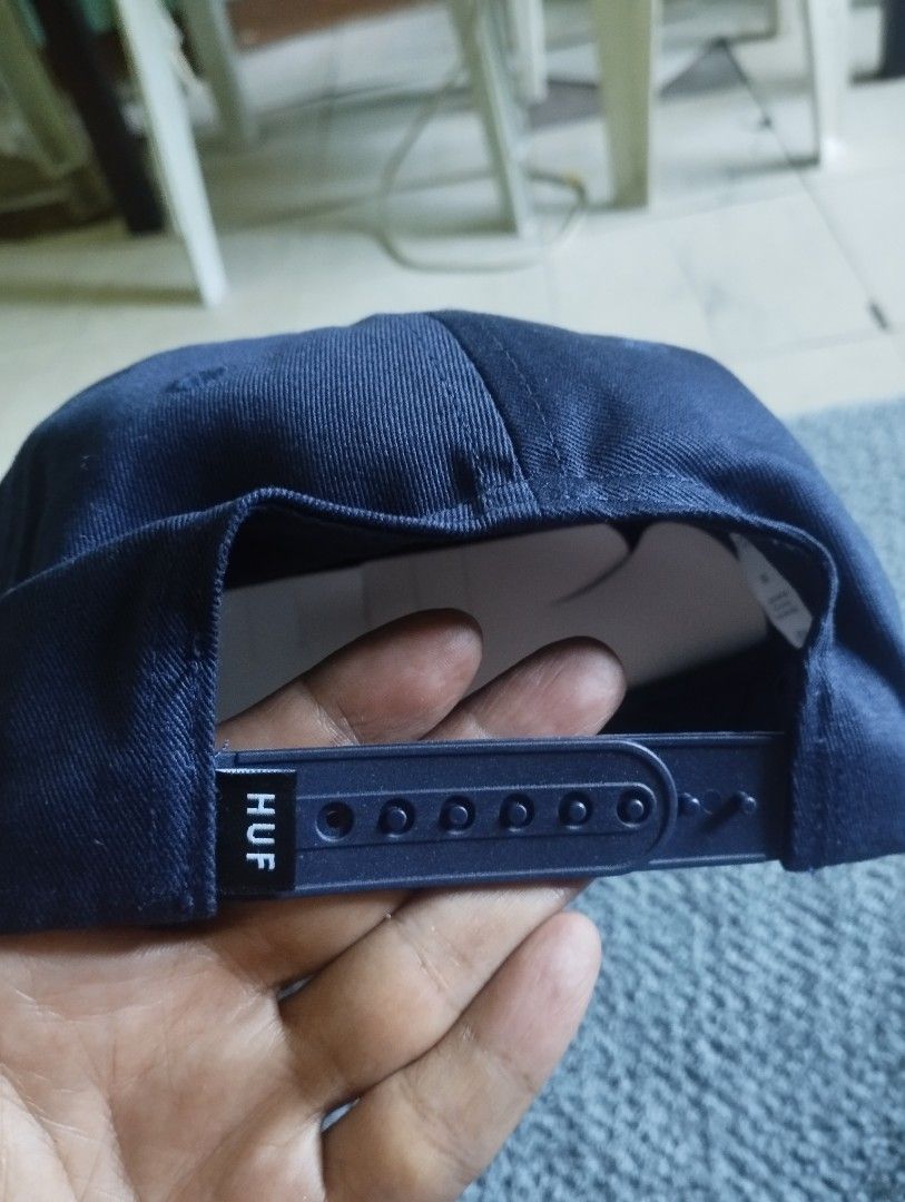 HUF Navy Blue Snapback Hat Cap (Category: Caps & Hats) located in Manila. Submitted by happycaps (Listing ID 1466172758, Image 2). Description: - Brand: HUF - Color: Navy Blue - Material: 100% Cotton twill - Design: Square woven patch logo on front - Fit: Adjustable plastic snap closure (One Size Fits All) - Condition: Clean fabric, great streetwear accessory.