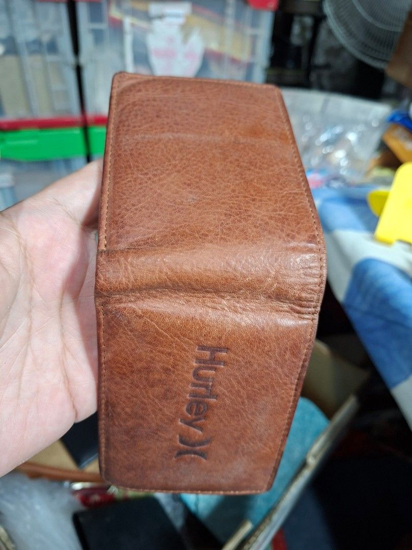 Hurley Brown Bi-Fold Leather Wallet (Category: Wallets & Card Holders) located in Lucena. Submitted by dai_suki (Listing ID 1466304993, Image 2). Description: Brown leather wallet from Hurley, debossed logo on the front. Plenty of card slots inside, plus a clear ID window and a zippered coin pocket. Main cash compartment is fabric lined. Good everyday size. 📌 Issue last pic po... JRS COURIER ONLY 1ST TO PAY.
