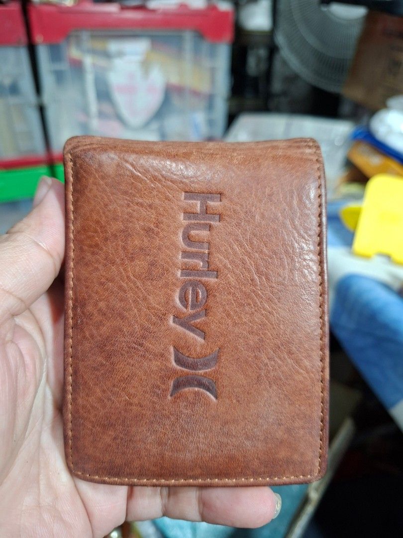 Hurley Brown Bi-Fold Leather Wallet (Category: Wallets & Card Holders) located in Lucena. Submitted by dai_suki (Listing ID 1466304993, Image 1). Description: Brown leather wallet from Hurley, debossed logo on the front. Plenty of card slots inside, plus a clear ID window and a zippered coin pocket. Main cash compartment is fabric lined. Good everyday size. 📌 Issue last pic po... JRS COURIER ONLY 1ST TO PAY.