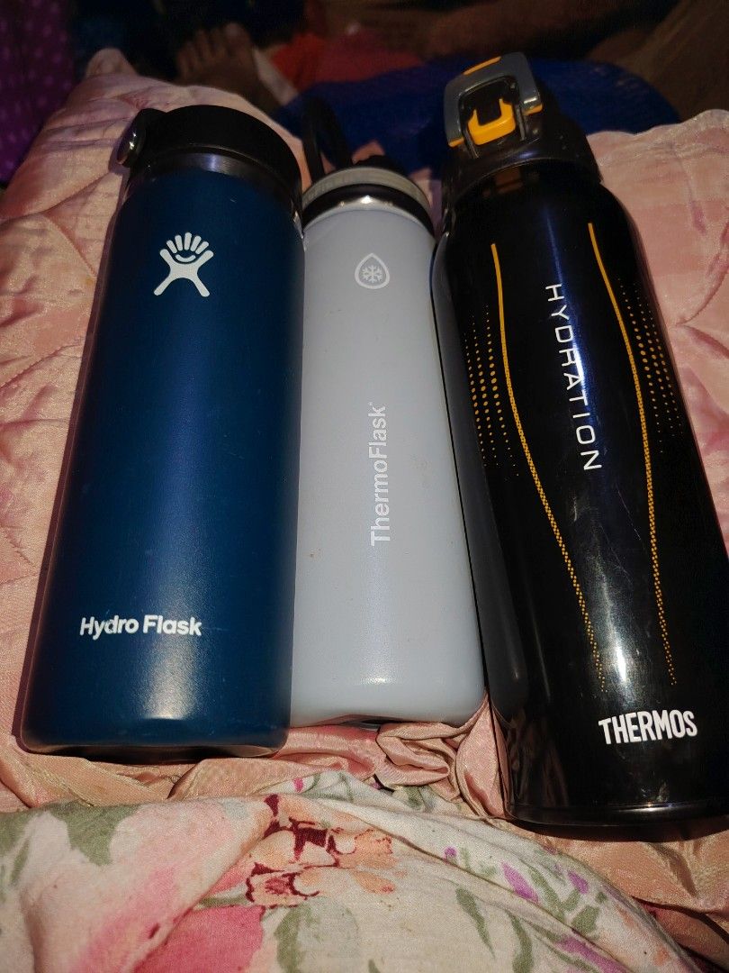 Hydro Flask Water Bottle Blue Grey Black Thermos (Category: Water Bottles & Tumblers) located in Manila. Submitted by purediamond888 (Listing ID 1466307006, Image 1). Description: Three water bottles total in this lot. Dark blue Hydro Flask with standard cap. Grey ThermoFlask featuring a snowflake symbol. Black Thermos Hydration bottle with yellow accents and a carry handle. All three ready for daily hydration needs. Great for gym, office, or out