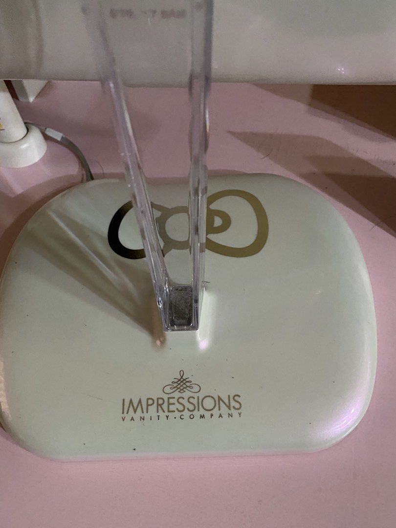 Impressions Vanity Hello Kitty Touch Pro LED Makeup Mirror (Category: Mirrors) located in Cavite. Submitted by momrocks (Listing ID 1466178761, Image 3). Description: Impressions Vanity Hello Kitty Touch Pro LED Makeup Mirror in pearl white. Key Features • Design: Features an iconic Hello Kitty bow graphic on the back and the character logo on the stand. • Lighting: Built-in daylight LED lighting strip with touch sensor controls to adjust brightn