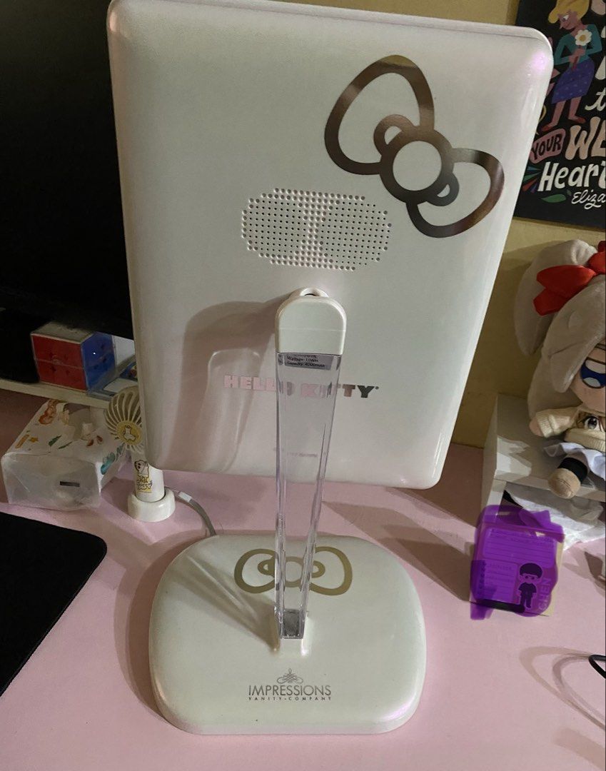 Impressions Vanity Hello Kitty Touch Pro LED Makeup Mirror (Category: Mirrors) located in Cavite. Submitted by momrocks (Listing ID 1466178761, Image 2). Description: Impressions Vanity Hello Kitty Touch Pro LED Makeup Mirror in pearl white. Key Features • Design: Features an iconic Hello Kitty bow graphic on the back and the character logo on the stand. • Lighting: Built-in daylight LED lighting strip with touch sensor controls to adjust brightn